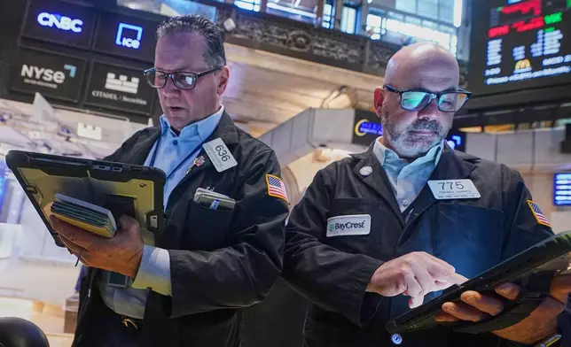 Traders Edward Curran, left, and Fred Demarco work on the floor of the New York Stock Exchange, Wednesday, June 3, 2026. (AP Photo/Richard Drew)