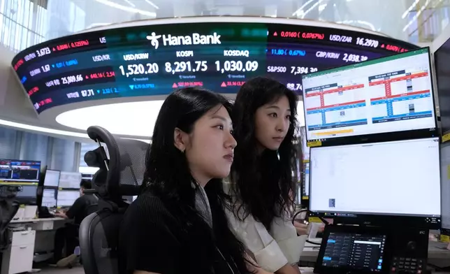 Currency traders watch monitors at the foreign exchange dealing room of the Hana Bank headquarters in Seoul, South Korea, Friday, June 12, 2026. (AP Photo/Ahn Young-joon)