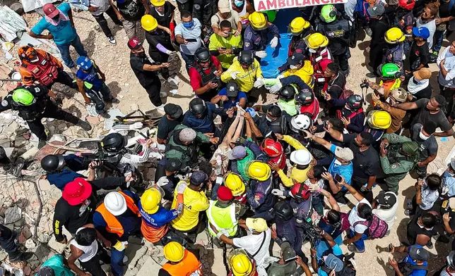 A person removed from the rubble by members of the French Civil Security Training and Intervention Regiment (UIISC 7), U.S. rescuers and others is carried on a stretcher to an ambulance along the coast in Caraballeda, La Guaira state, Venezuela, Sunday, June 28, 2026, after earthquakes. (Miguel Medina, Pool photo via AP)