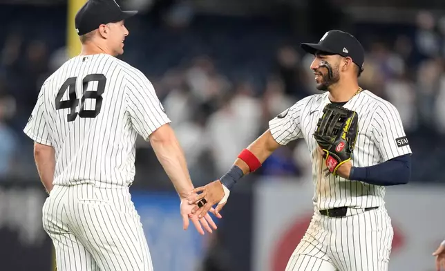 New York Yankees' Paul Goldschmidt, left, celebrates with José Caballero after a baseball game against the Chicago White Sox Wednesday, June 17, 2026, in New York. (AP Photo/Frank Franklin II)