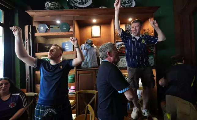 Scotland soccer fans with the Tartan Army play bagpipes, chant and dance in the Ball and Chain music bar before marching to a Miami Marlins against the Texas Rangers baseball game in Miami, Monday, June 22, 2026. (AP Photo/Rebecca Blackwell)