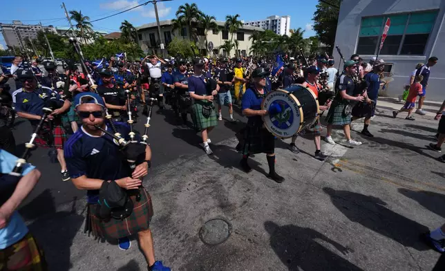 Scotland soccer fans march with the Tartan Army from Miami's Little Havana neighborhood on their way to a Miami Marlins against the Texas Rangers baseball game, Monday, June 22, 2026. (AP Photo/Rebecca Blackwell)