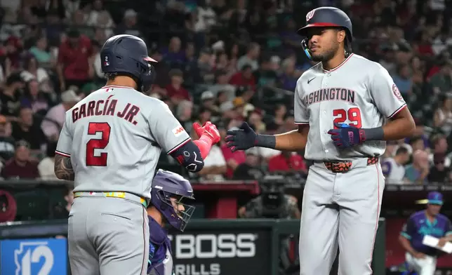 Washington Nationals' James Wood, right, celebrates with Luis García Jr. (2) after hitting a solo home run against the Arizona Diamondbacks in the third inning of a baseball game, Friday, June 5, 2026, in Phoenix. (AP Photo/Rick Scuteri)