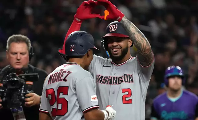 Washington Nationals' Luis García Jr. (2) celebrates with Nasim Nuñez, center left, after hitting a grand slam against the Arizona Diamondbacks in the sixth inning of a baseball game, Friday, June 5, 2026, in Phoenix. (AP Photo/Rick Scuteri)
