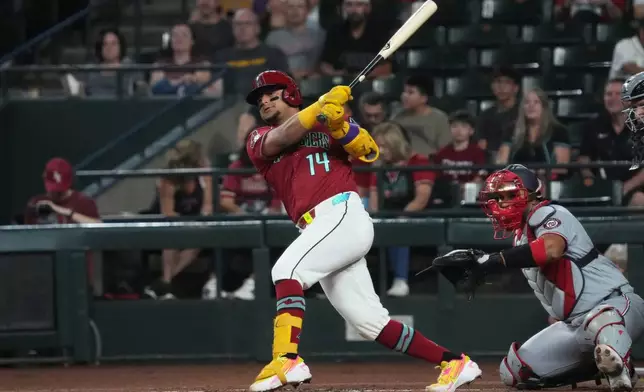 Arizona Diamondbacks' Gabriel Moreno (14) hits against the Washington Nationals in the first inning of a baseball game, Sunday, June 7, 2026, in Phoenix. (AP Photo/Rick Scuteri)
