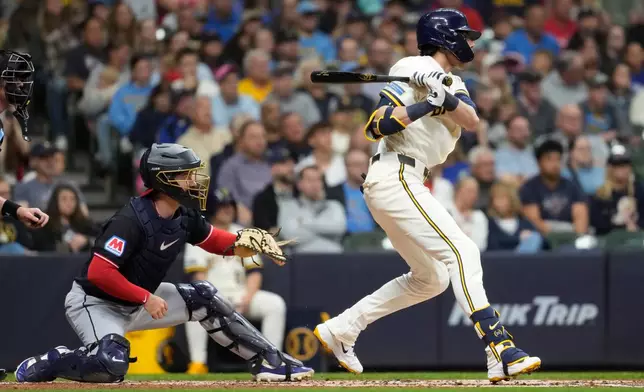 Milwaukee Brewers' Christian Yelich hits an RBI single during the second inning of a baseball game against the Cleveland Guardians, Wednesday, June 17, 2026, in Milwaukee. (AP Photo/Aaron Gash)