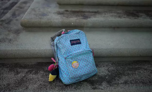 A backpack belonging to Makeda Walker-Deen, a junior at Susan Miller Dorsey Senior High School, sits on steps in Los Angeles, Thursday, May 14, 2026. (AP Photo/Jae C. Hong)