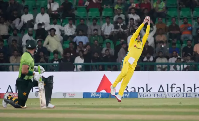 Australia's Adam Zampa, right, jumps to take a catch to dismiss Pakistan's Sahibzada Farhan, left, during the second one-day international cricket match between Pakistan and Australia, in Lahore, Pakistan, Tuesday, June 2, 2026. (AP Photo/K.M. Chaudary)