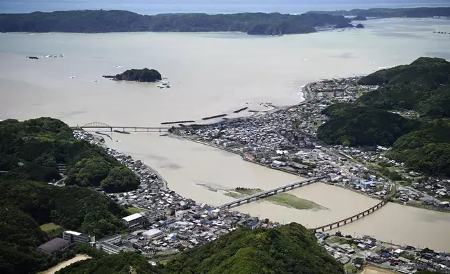 The mouth of the swollen Koza River is seen in Kushimoto town, Wakayama prefecture, central Japan, Wednesday, June 3, 2026, following a severe weather system in the area. (Tatsuya Sugawa/Kyodo News via AP)
