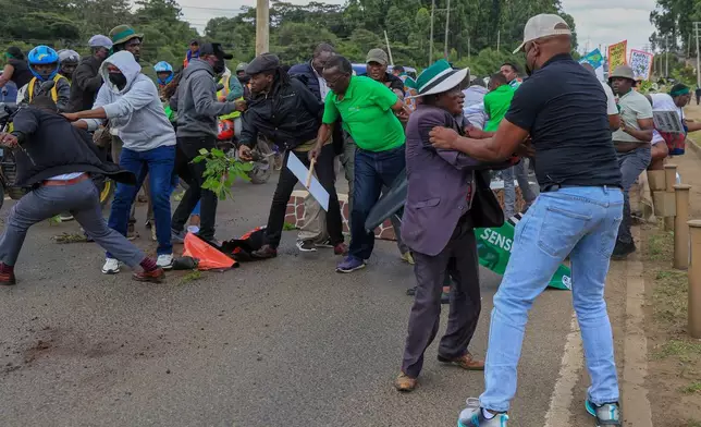 Plainclothes police officers arrest protesters during a demonstration against plans they say would affect wildlife habitat in Nairobi National Park in Nairobi, Kenya, Monday, June 8, 2026. (AP Photo/Andrew Kasuku)