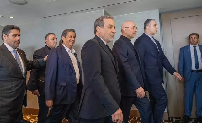 Minister of Foreign Affairs of Iran, Seyyed Abbas Araghchi, 3rd from right, and Speaker of the Islamic Parliament of Iran, Mohammed Bagher Ghalibaf, 2nd from right, with the Delegation of Iran at the Lake Lucerne Summit at the Buergenstock resort in Obbuergen, near Lucerne, Switzerland, Sunday, June 21, 2026. (Urs Flueeler, Pool Photo via AP)