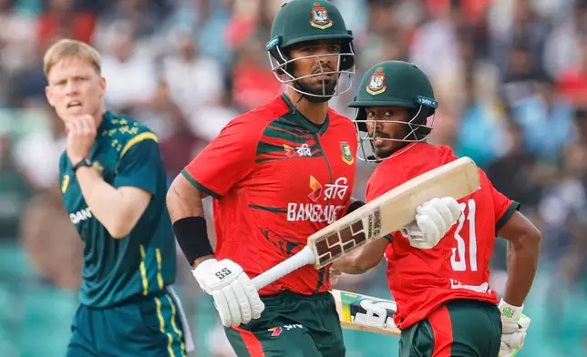 Bangladesh's Tanzid Hasan Tamim, right, and Saif Hassan run between the wickets to score during the second T20 international cricket match between Australia and Bangladesh, in Chattogram, Bangladesh, Friday, June 19, 2026. (AP Photo/Mosaraf Hossain)
