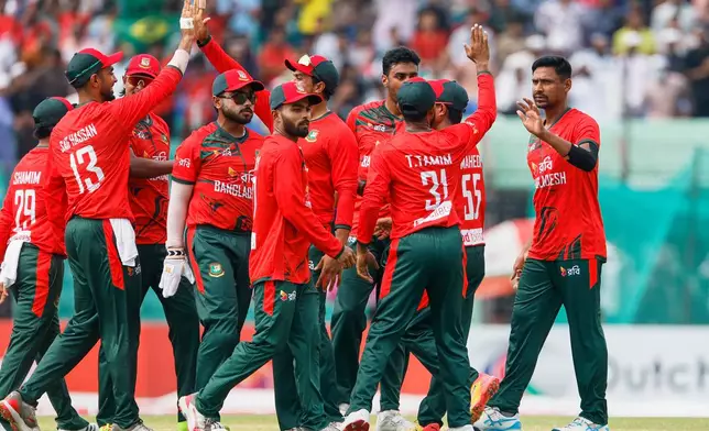Bangladesh's Mustafizur Rahman, right, celebrates with teammates the wicket of Australia's captain Mitchell Marsh during the second T20 international cricket match between Australia and Bangladesh, in Chattogram, Bangladesh, Friday, June 19, 2026. (AP Photo/Mosaraf Hossain)