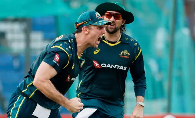 Australia's captain Mitchell Marsh reacts after taking the catch to dismiss Bangladesh's Parvez Hossain Emon during the second T20 international cricket match between Australia and Bangladesh, in Chattogram, Bangladesh, Friday, June 19, 2026. (AP Photo/Mosaraf Hossain)