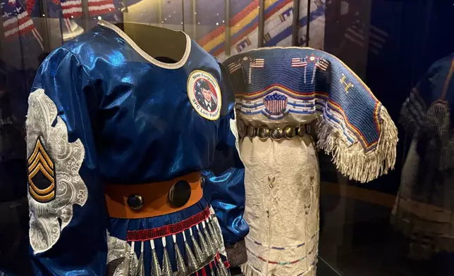 Two Native American dresses are on display as part of a commemoration of the 250th anniversary of the signing of the Declaration of Independence at the Smithsonian's National Museum of the American Indian in Washington, on Saturday, May 23, 2026. (Jourdan Bennett-Begaye/ICT via AP)