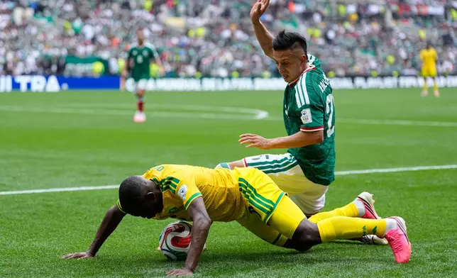 Mexico's Roberto Alvarado vies for the ball with South Africa's Aubrey Modiba, left, during the World Cup Group A soccer match between Mexico and South Africa in Mexico City, Thursday, June 11, 2026. (AP Photo/Natacha Pisarenko)