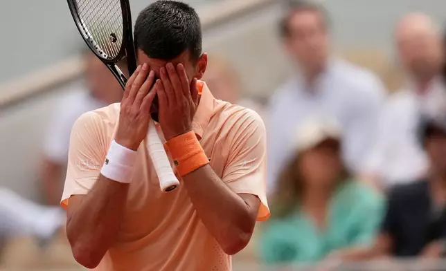 Novak Djokovic of Serbia reacts as he plays against Joao Fonseca of Brazil during their third round men's singles tennis match at the French Open tennis tournament in Paris, Friday, May 29, 2026. (AP Photo/Christophe Ena)