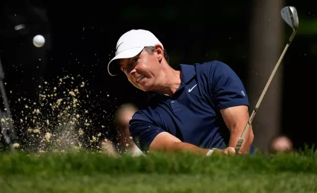 Rory McIlroy, of Northern Ireland, hits out of a bunker on the seventh hole during the first round of the Memorial golf tournament in Dublin, Ohio, Thursday, June 4, 2026. (AP Photo/Sue Ogrocki)