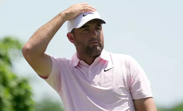 Scottie Scheffler watches his tee shot from the fifth tee during the first round of the Memorial golf tournament in Dublin, Ohio, Thursday, June 4, 2026. (AP Photo/Sue Ogrocki)