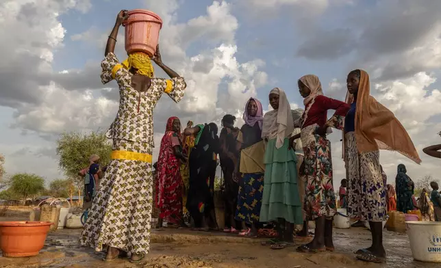 FILE - Women and children fetch water at dusk in the Korsi Refugee Camp in Birao, the Central African Republic, Friday, March 27, 2026. (AP Photo/Caitlin Kelly, File)