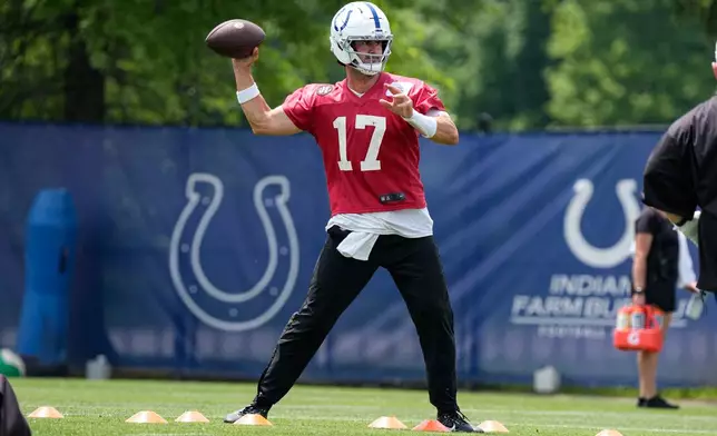 Indianapolis Colts quarterback Daniel Jones (17) throws during the NFL football team's practice in Indianapolis, Tuesday, June 9, 2026. (AP Photo/Michael Conroy)
