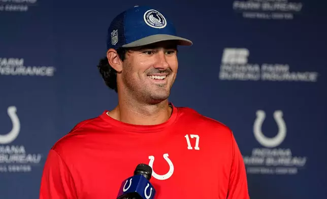 Indianapolis Colts quarterback Daniel Jones (17) speaks before the NFL football team's practice in Indianapolis, Tuesday, June 9, 2026. (AP Photo/Michael Conroy)