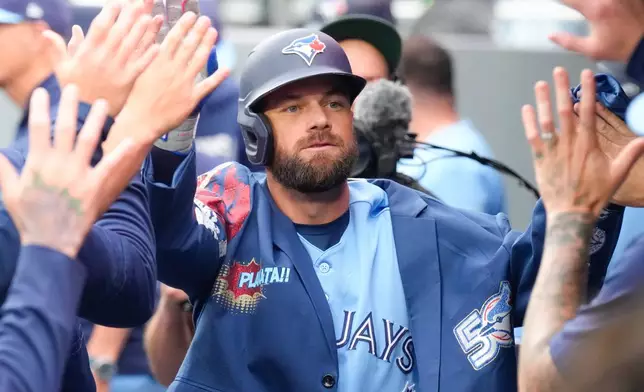 Toronto Blue Jays' Nathan Lukes (38) celebrates in the dug out after hitting a solo home run against the Houston Astros during the first inning of a baseball game in Toronto on Wednesday, June 24, 2026. (Chris Young/The Canadian Press via AP)