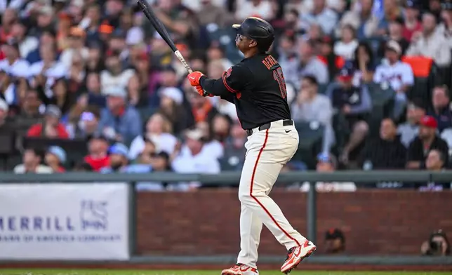 San Francisco Giants' Rafael Devers (16) hits a three-run home run for his second of the night during the third inning of a baseball game Atlanta Braves, Saturday, June 27, 2026, in San Francisco (AP Photo/Justine Willard)