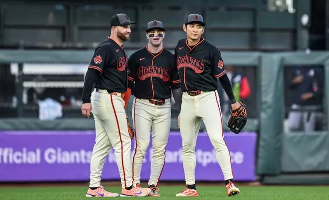 San Francisco Giants Casey Schmitt (10), Drew Gilbert (0) and Jung Hoo Lee (51) celebrate after their win against the Atlanta Braves in a baseball game, Saturday, June 27, 2026, in San Francisco (AP Photo/Justine Willard)