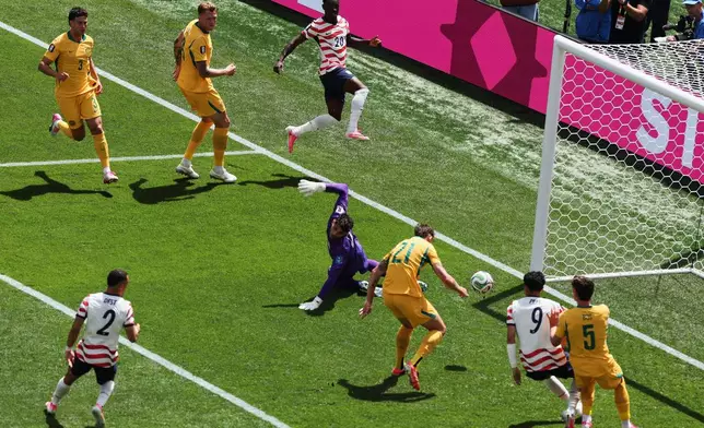 Australia's Cameron Burgess (21) scores an own goal during the World Cup Group D soccer match between the United States and Australia in Seattle, Friday, June 19, 2026. (AP Photo/Maddy Grassy)