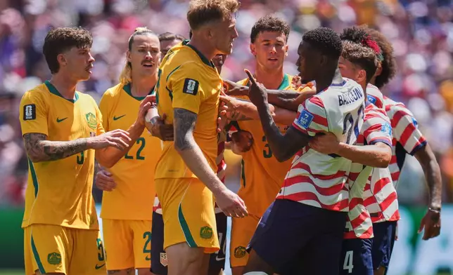Australia's Harry Souttar (19), foreground left, and United States' Folarin Balogun (20), foreground right, argue during the World Cup Group D soccer match between the United States and Australia in Seattle, Friday, June 19, 2026. (AP Photo/Manu Fernandez)