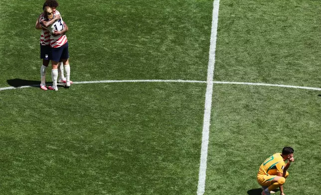 United States' Chris Richards (3) and Tim Ream (13) celebrate as Australia's Cristian Volpato (20) reacts after the World Cup Group D soccer match between the United States and Australia in Seattle, Friday, June 19, 2026. (AP Photo/Maddy Grassy)