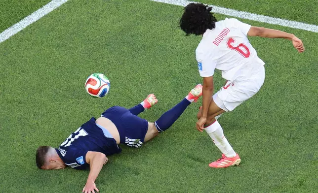 Scotland's Lewis Ferguson (19) and Morocco's Ayyoub Bouaddi (6) battle for the ball during the World Cup Group C soccer match between Scotland and Morocco in Foxborough, Mass., near Boston, Friday, June 19, 2026. (AP Photo/Mark Stockwell)