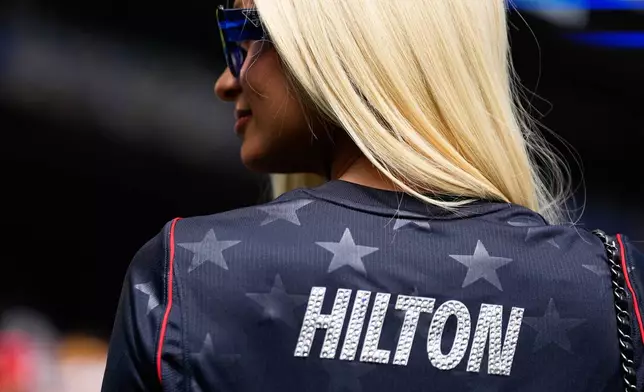 Paris Hilton stands on the pitch before the World Cup Group D soccer match between the United States and Australia in Seattle, Friday, June 19, 2026. (AP Photo/Lindsey Wasson)