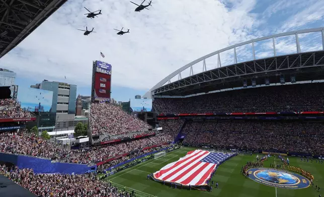 Helicopters fly over the stadium before the World Cup Group D soccer match between the United States and Australia in Seattle, Friday, June 19, 2026. (AP Photo/Maddy Grassy)