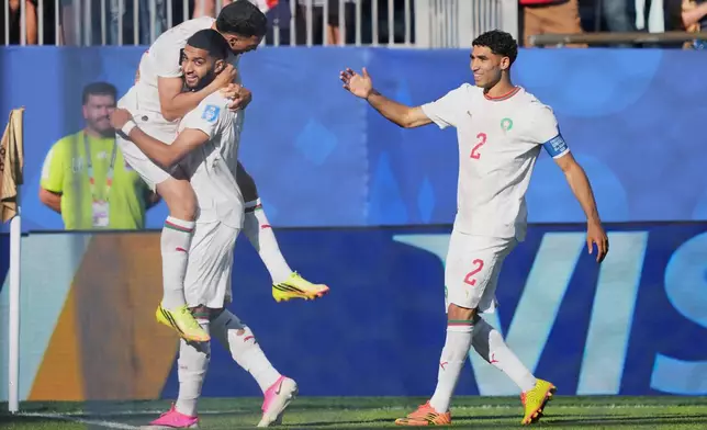 Morocco's Ismael Saibari, bottom left, is congratulated after scoring his side's opening goal during the World Cup Group C soccer match between Scotland and Morocco in Foxborough, Mass., near Boston, Friday, June 19, 2026. (AP Photo/Martin Meissner)