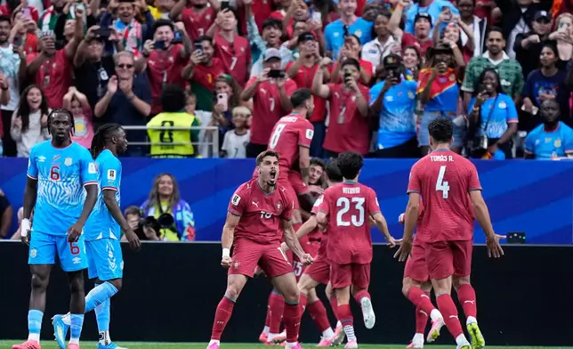 Portugal's Pedro Neto, center, celebrates after teammate Joao Neves scored the opening goalduring the World Cup Group K soccer match between Portugal and Congo in Houston, Wednesday, June 17, 2026. (AP Photo/Ashley Landis)