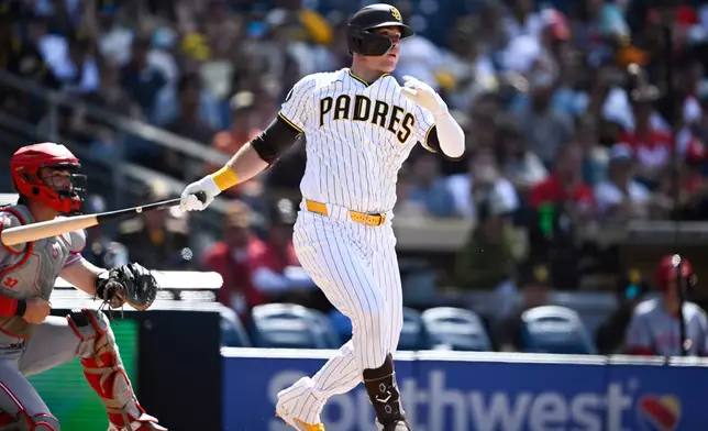 San Diego Padres' Gavin Sheets hits an RBI double during the eighth inning of a baseball game against the Cincinnati Reds, Wednesday, June 10, 2026, in San Diego. (AP Photo/Denis Poroy)