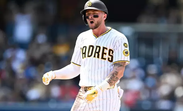 San Diego Padres' Jackson Merrill (3) celebrates after hitting a double during the eighth inning of a baseball game against the Cincinnati Reds Wednesday, June 10, 2026, in San Diego. (AP Photo/Denis Poroy)
