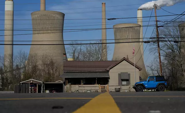FILE - American Electric Power's John Amos coal-fired plant in Winfield, W.Va., is seen from Poca, W.Va., March 22, 2026. (AP Photo/Carolyn Kaster, File)