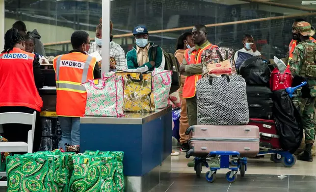 The National Disaster Management Organisation (NADMO) assists Ghanaian nationals repatriated from South Africa upon their arrival at the Accra International Airport in Accra, Ghana, Wednesday, May 27, 2026. (AP Photo/Tsraha Yaw)