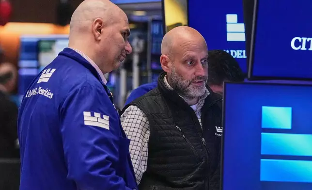 Specialists Philip Finale, left, and Meric Greenbaum work on the floor of the New York Stock Exchange, Friday, May 29, 2026. (AP Photo/Richard Drew)