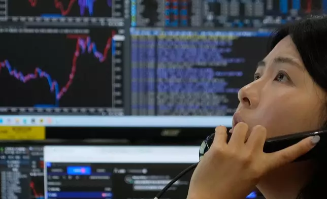 A currency trader talks on the phone at the foreign exchange dealing room of the Hana Bank headquarters in Seoul, South Korea, Monday, June 1, 2026. (AP Photo/Ahn Young-joon)