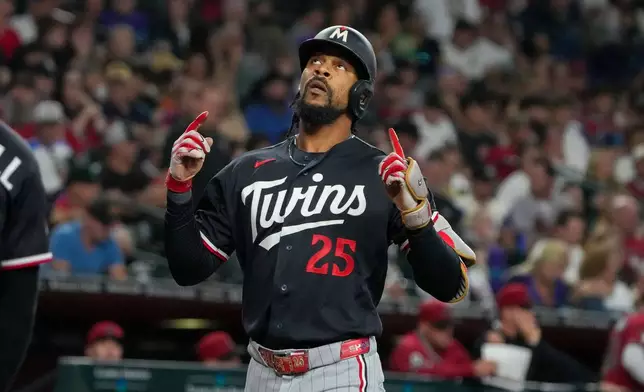 Minnesota Twins center fielder Byron Buxton looks skyward after hitting a grand slam against the Arizona Diamondbacks in the fifth inning of a baseball game Saturday, June 20, 2026, in Phoenix. (AP Photo/Darryl Webb)