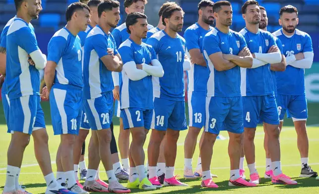 Iranian players listen to head coach Amir Ghalenoei during a training session ahead of their FIFA World Cup match against Belgium in Carson, Calif., Saturday, June 20, 2026. (AP Photo/Andre Penner)