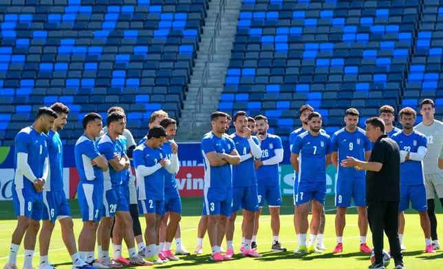 Iranian players listen to head coach Amir Ghalenoei during a training session ahead of their FIFA World Cup match against Belgium in Carson, Calif., Saturday, June 20, 2026. (AP Photo/Andre Penner)