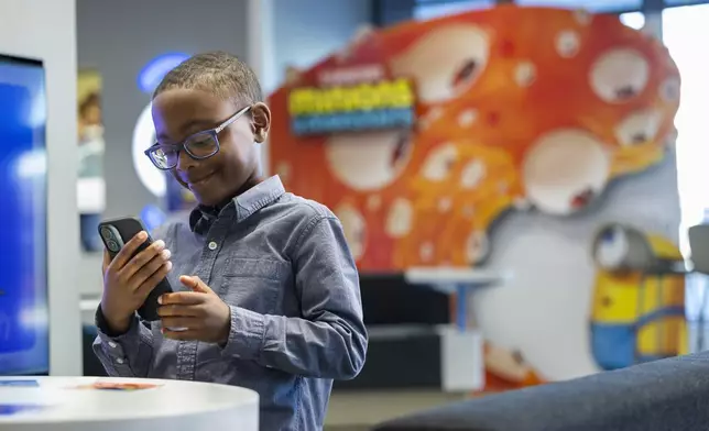 Xfinity members seen at an Xfinity Store, on Monday, June 15, 2026, experiencing Xfinity's activation for Illumination's Minions & Monsters featuring exclusive AR experiences, collectible drops and photo moments. King of Prussia, Penn. (Ryan Collerd/AP Content Services for Comcast)