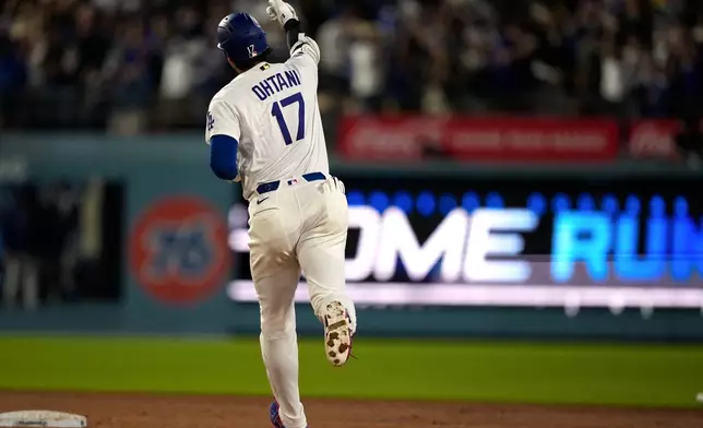 Los Angeles Dodgers' Shohei Ohtani gestures as he rounds second after hitting a solo home run during the sixth inning of a baseball game against the Tampa Bay Rays, Tuesday, June 16, 2026, in Los Angeles. (AP Photo/Mark J. Terrill)