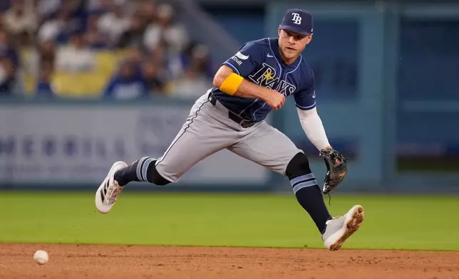 Tampa Bay Rays shortstop Taylor Walls fields a ball hit by Los Angeles Dodgers' Andy Pages before throwing him out at first during the sixth inning of a baseball game Tuesday, June 16, 2026, in Los Angeles. (AP Photo/Mark J. Terrill)