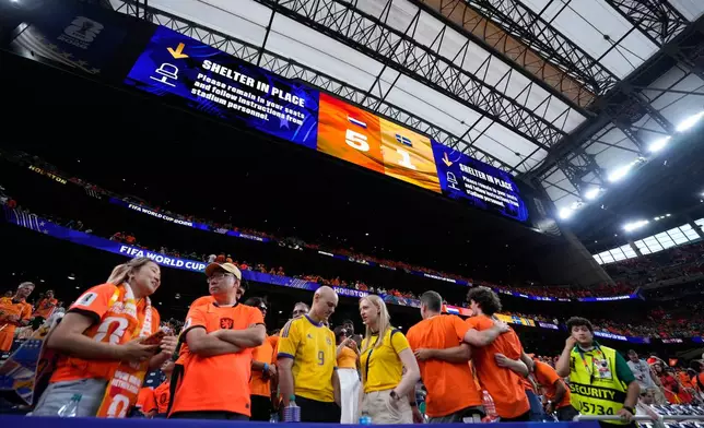 The video screen shows the final score and a Shelter in Place order due to the weather at the the end of the World Cup Group F soccer match between the Netherlands and Sweden in Houston, Saturday, June 20, 2026. (AP Photo/Ashley Landis)